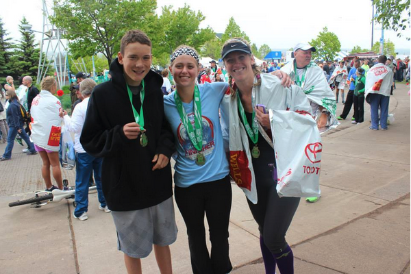 Jessica with her family at the finish line of an event.