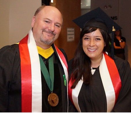 A graduation photo of Alexandria Skoch standing with Dr. John Katers.