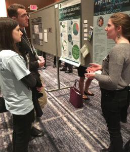 Sarah Voska talks about her capstone project with fellow event attendees. 