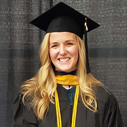 Headshot of Kristie Skul wearing her graduate cap and gown.