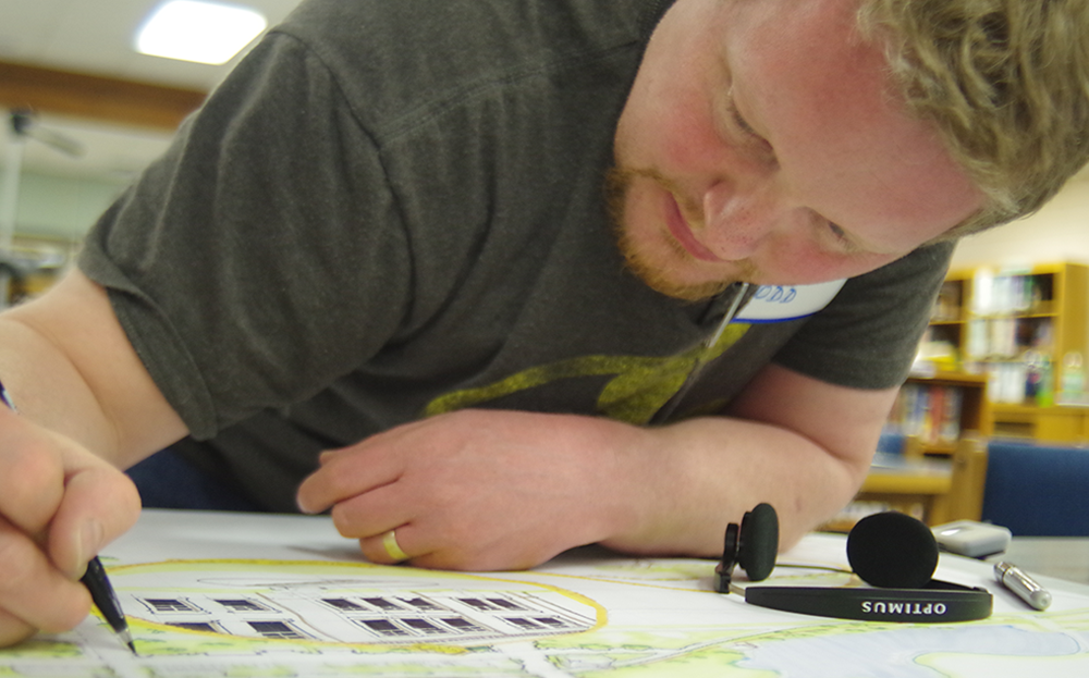 UW instructor, Todd Johnson, drawing an architecture design.