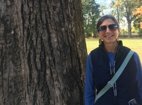 Beth Churchill smiling while on a hike.