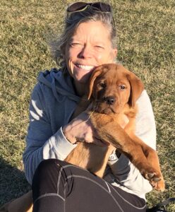 Dr. Betsy Barrett hugging her dog named Mello.