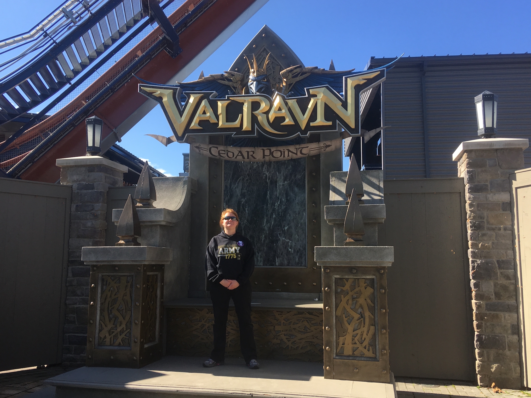 Sheilah Fondren standing in front of the Valravn rollercoaster at Cedar Point amusement park.