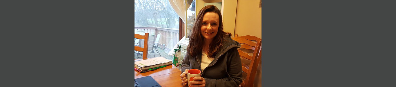 UW Sustainable Management graduate Sarah Wambach drinking her morning coffee.