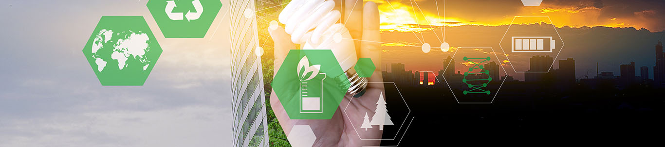 hand holding a light bulb with green energy and sustainablity symbols in the foreground
