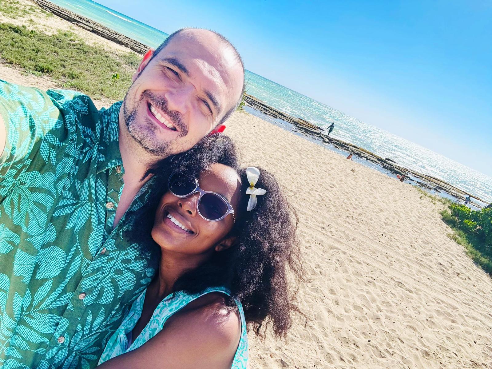 Nene taking a photo with her husband at the beach. 