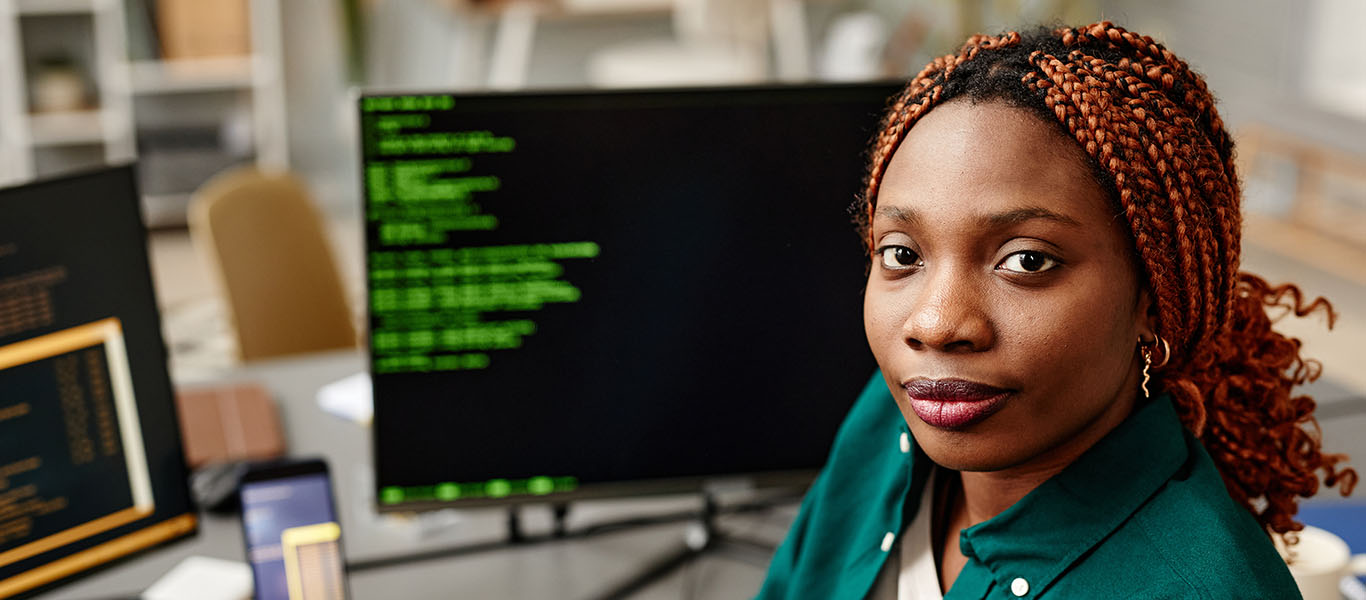 A young woman sitting at her computer in the office.