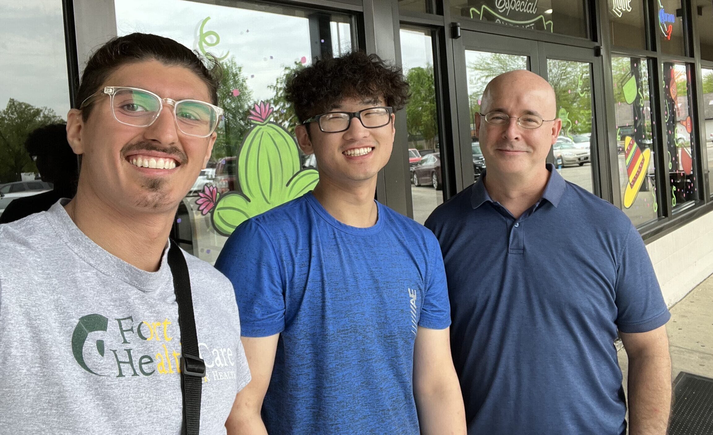 Bob Kuzoff celebrating with research students Jeton and Jon after their graduation.