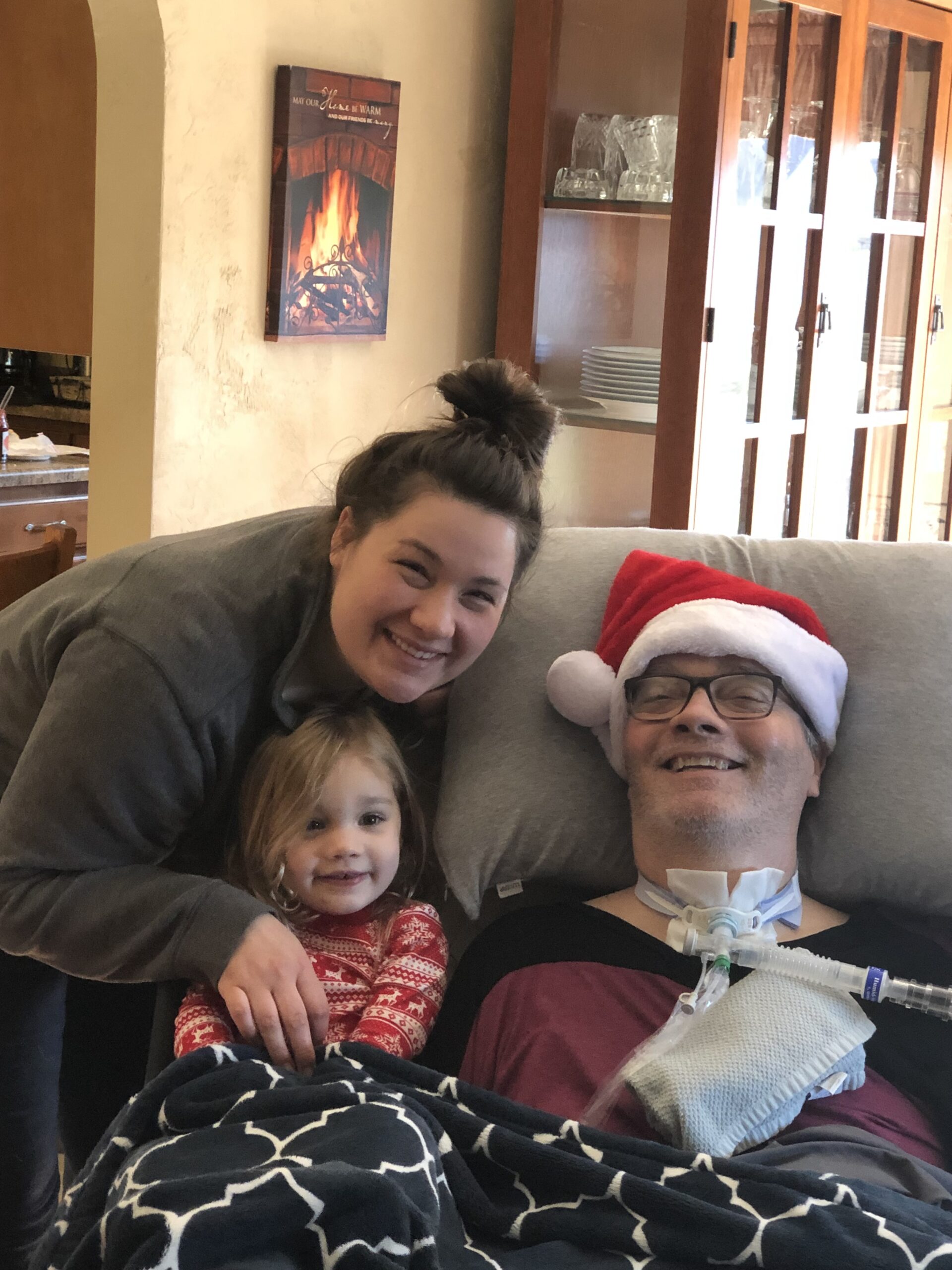 Britni smiles next to her father and daughter during the holidays. 