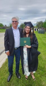 UW-Green Bay master's graduate Daxton Castellanos and her father at graduation