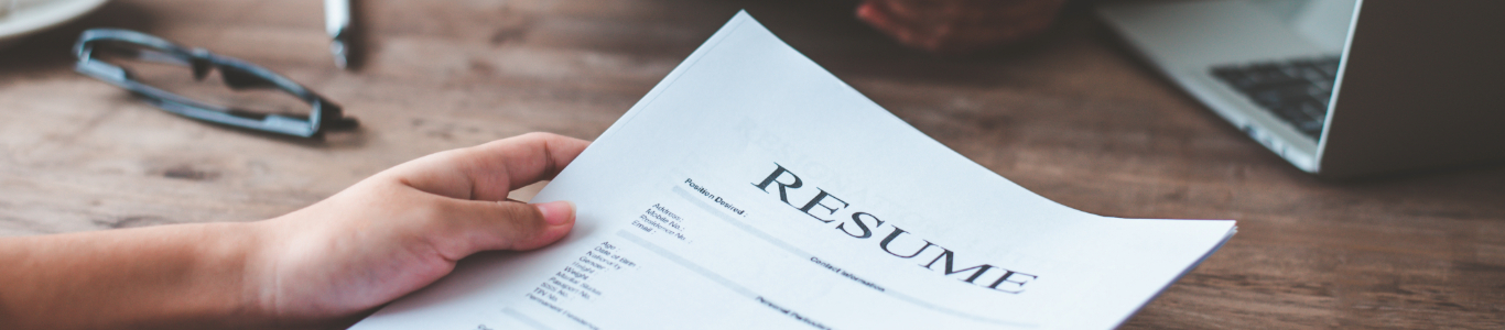 person holding a resume in their hand at a job interview