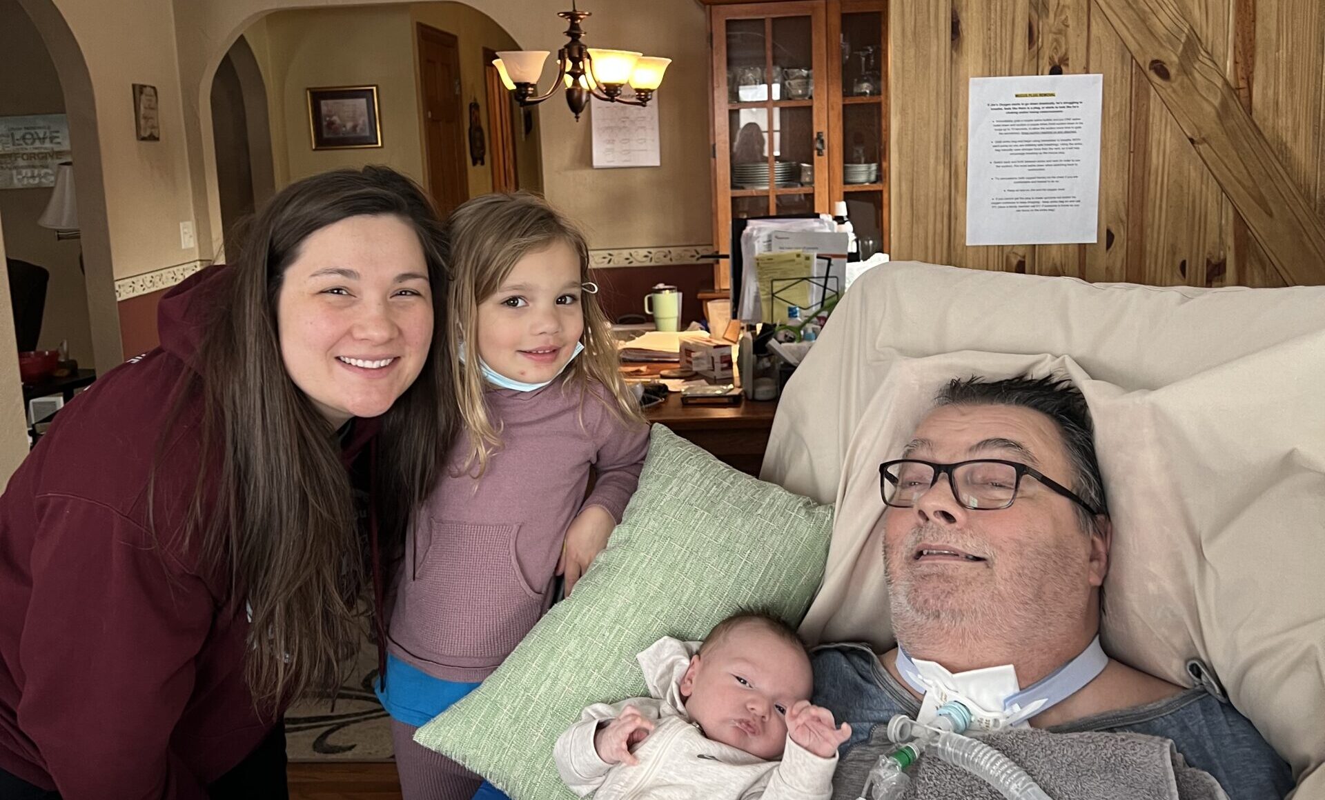 Britni Adams taking a photo with two of her children and her late father.