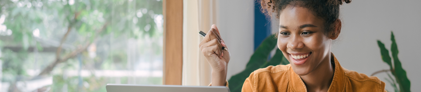 A female master’s student studies online on a laptop in her home