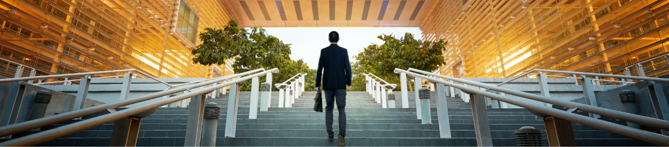 man walking up stairs carrying a briefcase